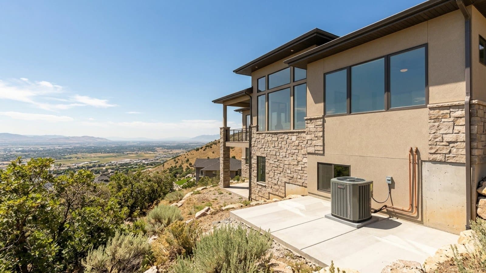New AC condenser on the patio of a modern hillside luxury home with panoramic Salt Lake Valley views in Draper, Utah